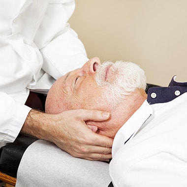 Older gentleman about to have a neck adjustment at Chiropractic Center of Longmont